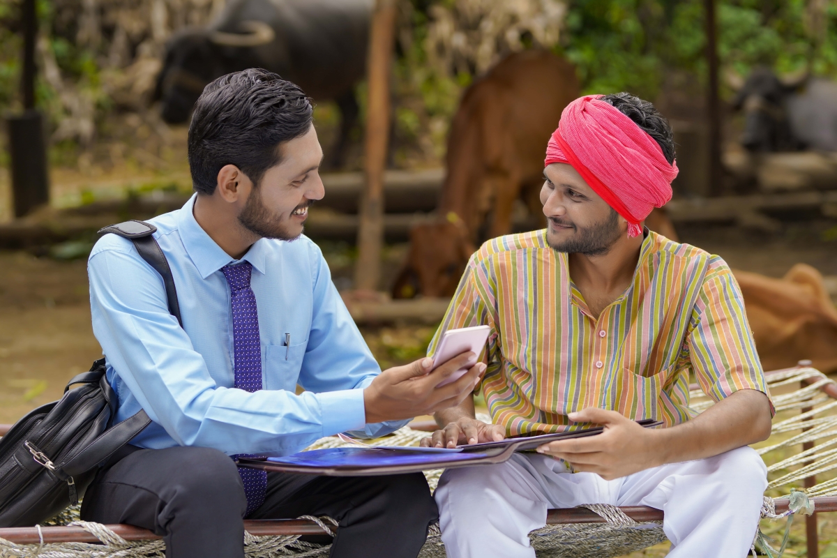 https://blog.credgenics.com/wp-content/uploads/2023/08/Optimized-young-indian-banker-agronomist-showing-some-detail-farmer-smartphone-min.jpg?utm_source=chatgpt.com